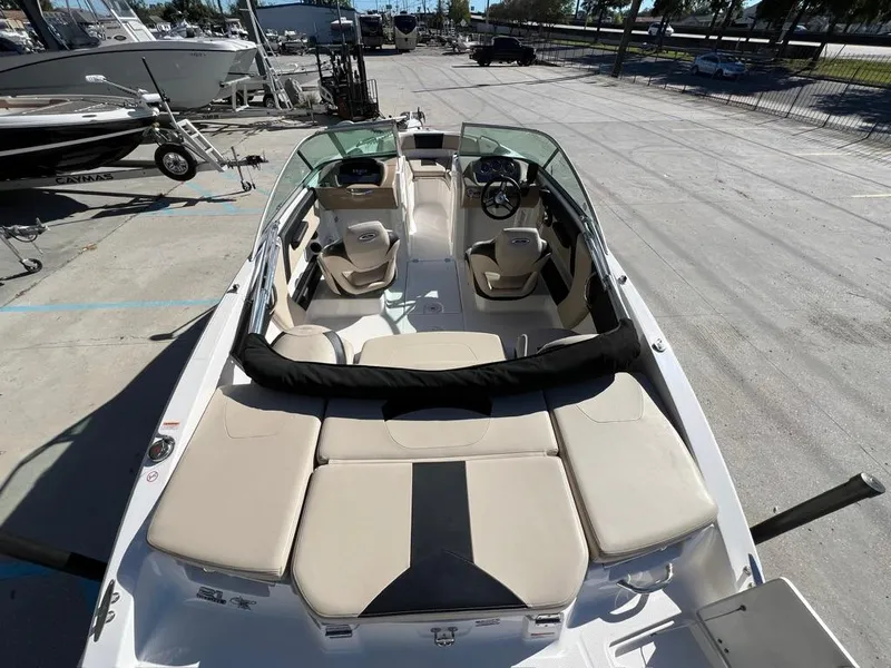Slide: The Image of 2017 Chaparral H20 boat with beige seating, docked outdoors in a marina. - 8