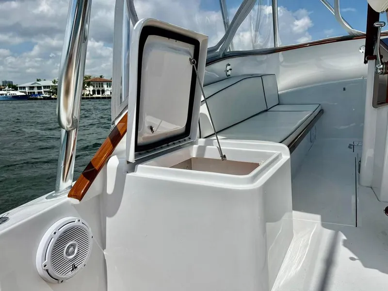 Slide: The Image of 1999 Gamefisherman 34 Express boat interior with open storage compartment and seating. - 10
