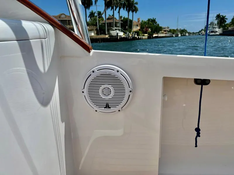 Slide: The Image of 1999 Gamefisherman 34 Express boat interior with speaker, docked by waterfront homes. - 12