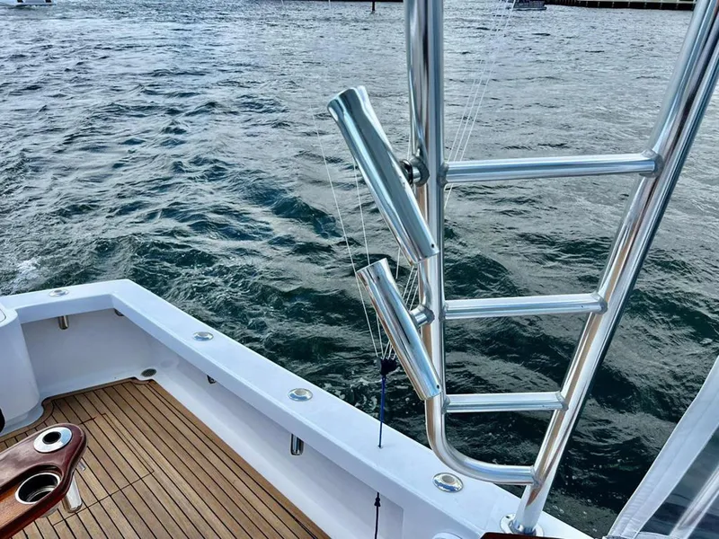 Slide: The Image of 1999 Gamefisherman 34 Express boat deck with rod holders and ocean view. - 13