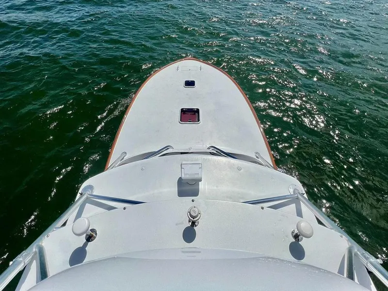 Slide: The Image of Bow view of 1999 Gamefisherman 34 Express boat on water. - 14