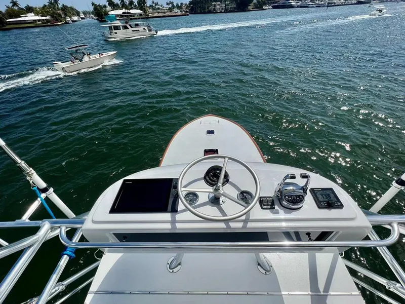 Slide: The Image of 1999 Gamefisherman 34 Express boat helm with ocean view and passing vessels. - 16