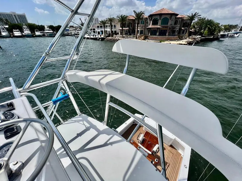 Slide: The Image of 1999 Gamefisherman 34 Express yacht with marina view and luxury waterfront homes. - 17