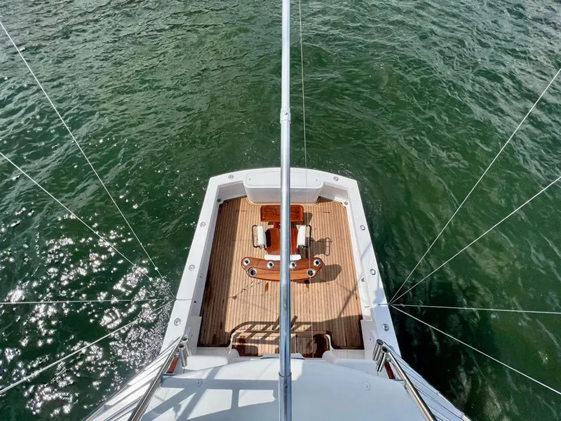 Slide: The Image of Overhead view of 1999 Gamefisherman 34 Express boat deck on water. - 18