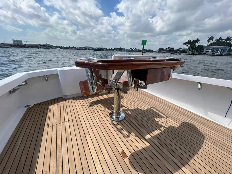 Slide: The Image of 1999 Gamefisherman 34 Express boat deck with wooden flooring and fishing station. - 23