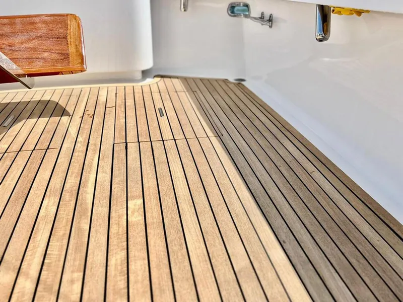 Slide: The Image of Teak deck of 1999 Gamefisherman 34 Express boat, showcasing clean lines and craftsmanship. - 26