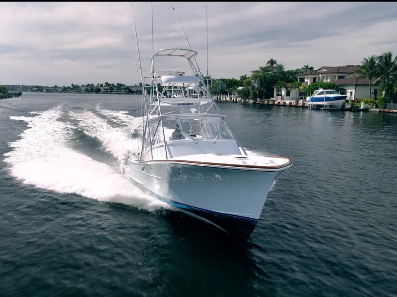 Slide: The Image of 1999 Gamefisherman 34 Express cruising on a scenic waterway. - 33