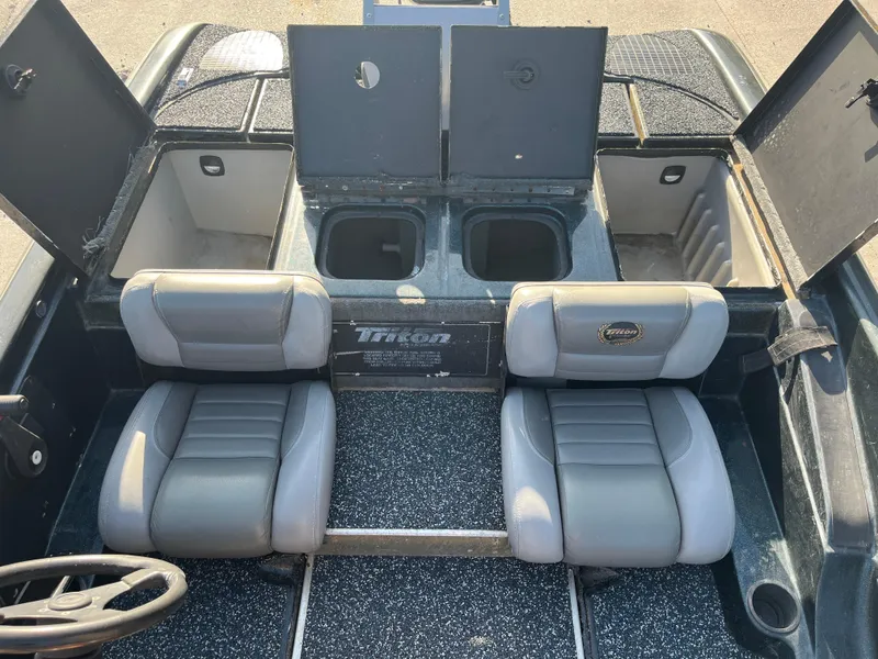 Slide: The Image of 1998 Triton Tr-17 boat interior with two seats and storage compartments. - 11
