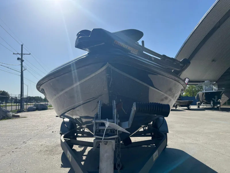 Slide: The Image of 1998 Triton Tr-17 boat on trailer under clear blue sky. - 2