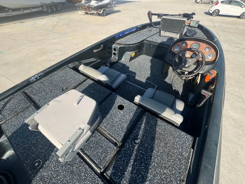 Slide: The Image of 1998 Triton Tr-17 boat interior with steering wheel, seats, and control panel. - 7