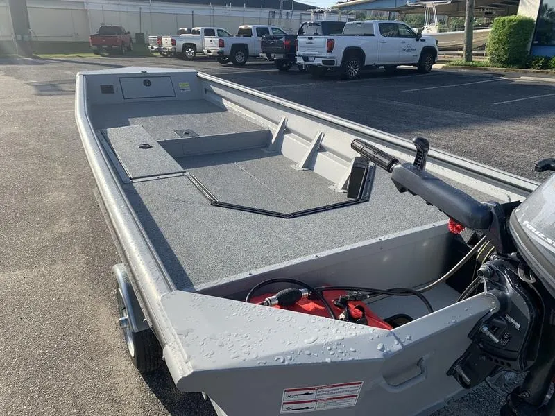 Slide: The Image of 2025 SeaArk DXS 1548 DKLD boat in parking lot, showcasing interior and motor. - 10