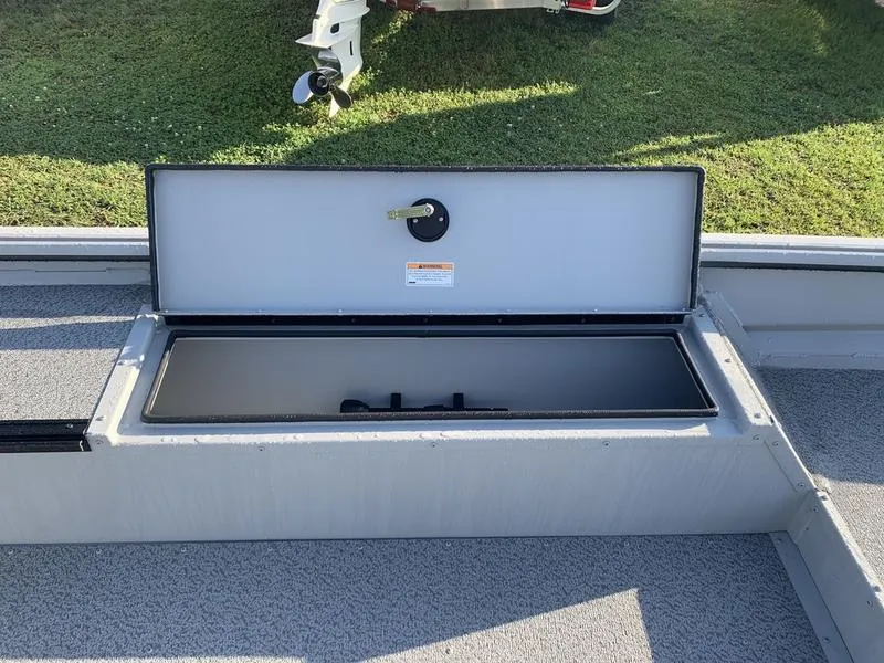 Slide: The Image of 2025 SeaArk DXS 1548 DKLD boat storage compartment open on deck. - 13