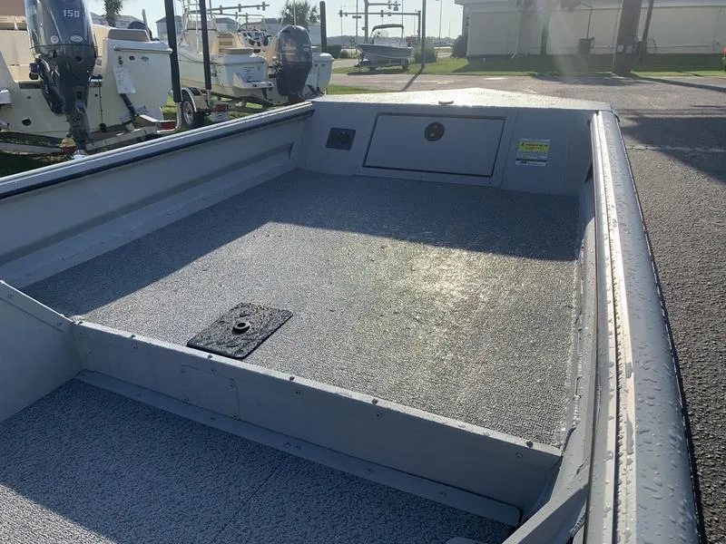 Slide: The Image of 2025 SeaArk DXS 1548 DKLD boat interior, featuring spacious deck and storage compartments. - 14