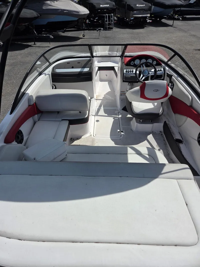 Slide: The Image of 2017 Regal 1900 ES Bowrider interior with white and red seating, dashboard view. - 8