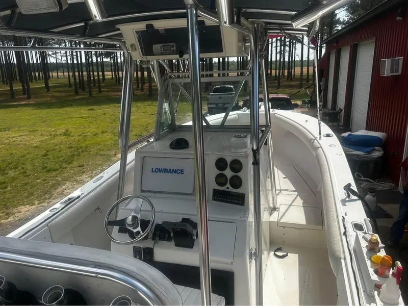 Slide: The Image of 1998 Regulator 26 Classic boat with steering console and Lowrance navigation system. - 3