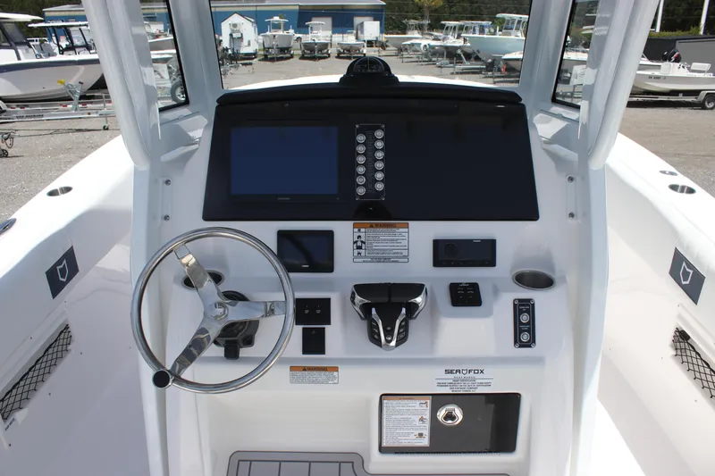 Slide: The Image of 2025 Sea Fox 268 Commander boat dashboard with steering wheel and control panel. - 12