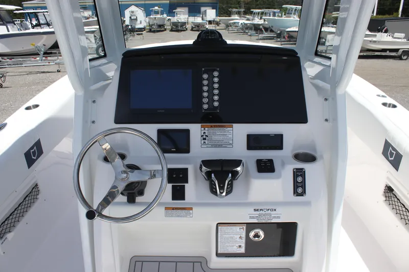 Slide: The Image of 2025 Sea Fox 268 Commander boat dashboard with steering wheel and control panel. - 13