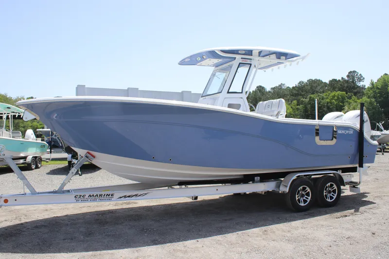 Slide: The Image of 2025 Sea Fox 268 Commander boat on trailer, blue hull, parked outdoors. - 4