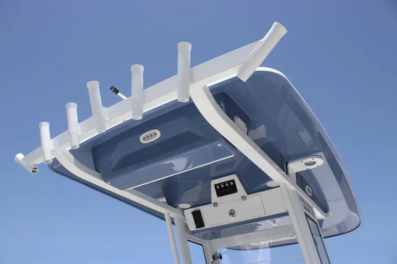Slide: The Image of 2025 Sea Fox 268 Commander boat roof with rod holders against clear sky. - 40