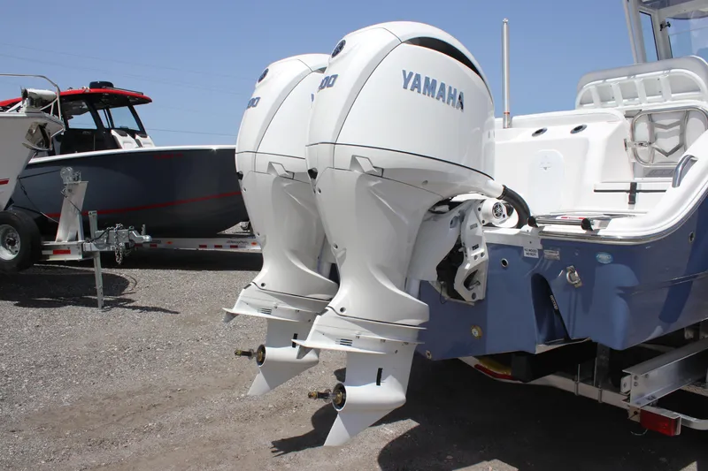 Slide: The Image of 2025 Sea Fox 268 Commander with dual Yamaha outboard engines, parked on gravel. - 8