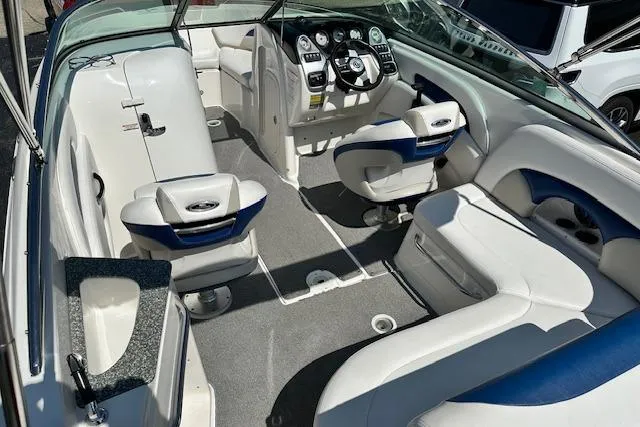 Slide: The Image of 2007 Chaparral SSX 236 boat interior with white and blue seating, steering console, and dashboard. - 10