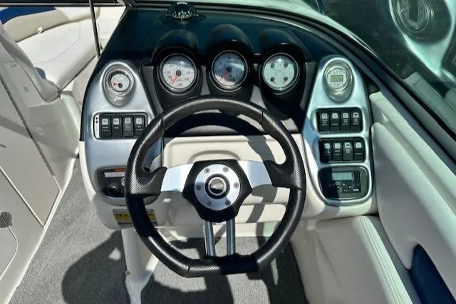 Slide: The Image of Steering wheel and dashboard of 2007 Chaparral SSX 236 boat, featuring gauges and controls. - 14