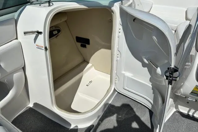 Slide: The Image of 2007 Chaparral SSX 236 boat storage compartment with open door, showcasing interior space. - 24