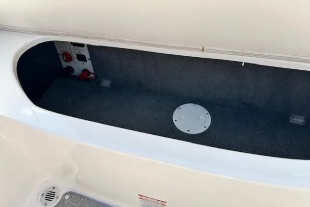 Slide: The Image of Storage compartment of a 2007 Chaparral SSX 236 boat, featuring a clean interior. - 28