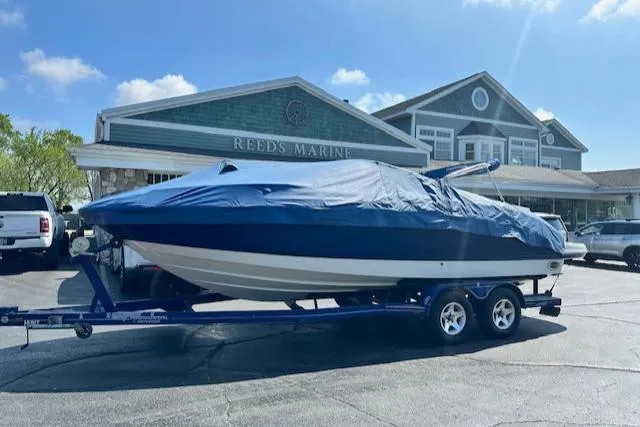 Slide: The Image of 2007 Chaparral SSX 236 boat covered on trailer at Reeds Marine dealership. - 30