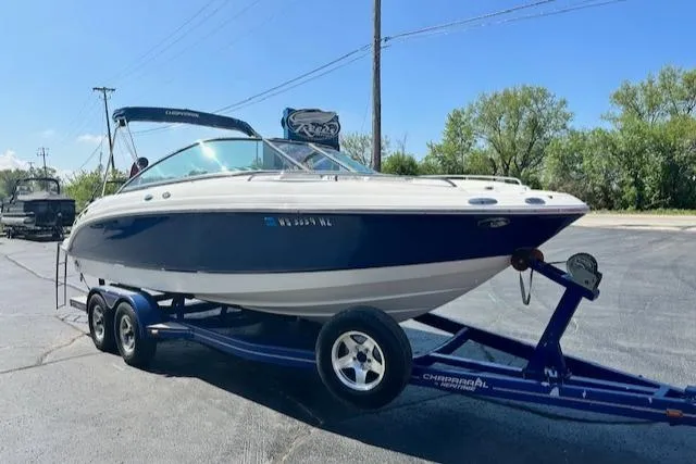 Slide: The Image of 2007 Chaparral SSX 236 boat on trailer, parked outdoors under clear blue sky. - 5