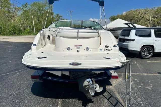 Slide: The Image of 2007 Chaparral SSX 236 boat, rear view, parked on asphalt with ladder and canopy. - 6