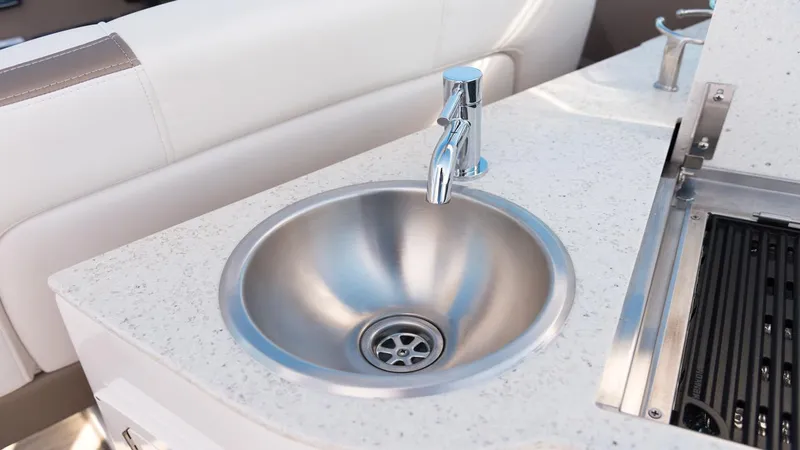 Slide: The Image of Stainless steel sink on 2026 Regal 33 XO boat with modern countertop. - 11