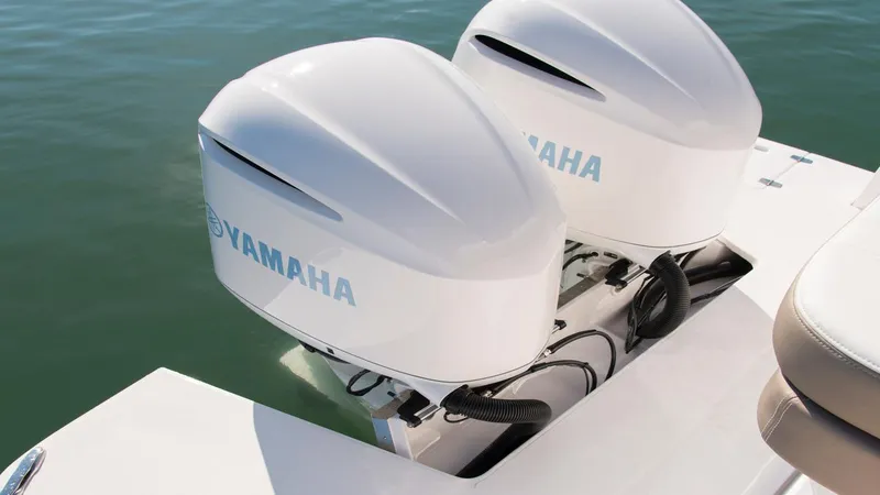 Slide: The Image of Twin Yamaha outboard engines on a 2026 Regal 33 XO boat, floating on calm water. - 14