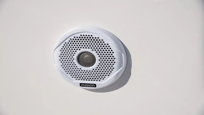 Slide: The Image of White Fusion speaker on 2026 Regal 33 XO boat exterior. - 16