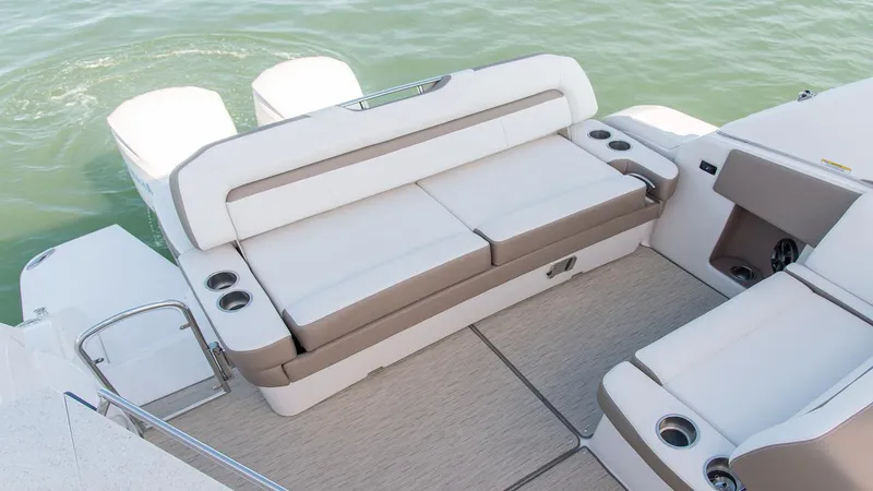 Slide: The Image of 2026 Regal 33 XO boat interior with comfortable seating and cup holders on calm water. - 20