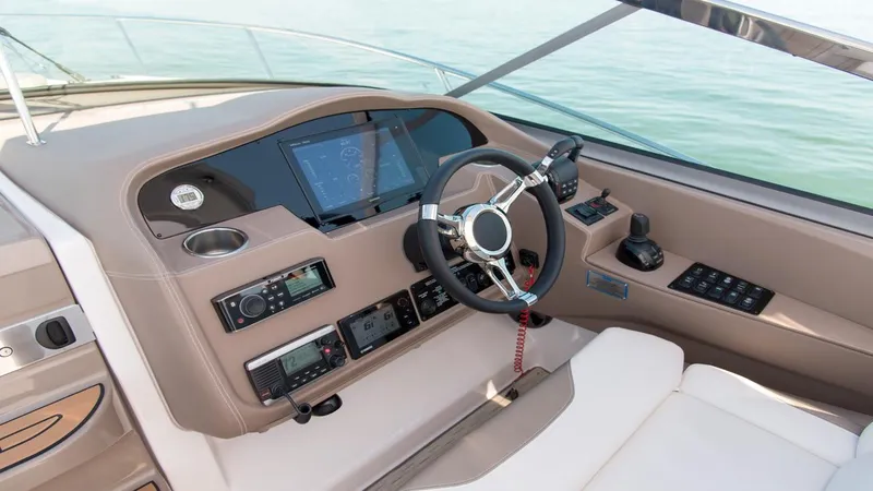 Slide: The Image of 2026 Regal 33 XO boat cockpit with modern controls and steering wheel on open water. - 23