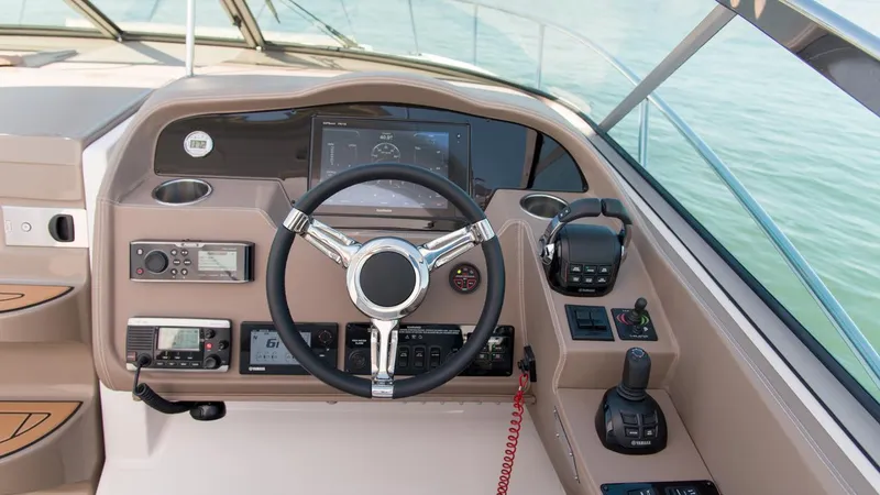 Slide: The Image of Helm of 2026 Regal 33 XO boat with modern controls and steering wheel. - 24