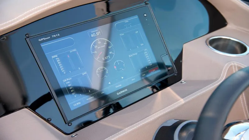 Slide: The Image of Dashboard of 2026 Regal 33 XO boat featuring Garmin navigation display. - 25