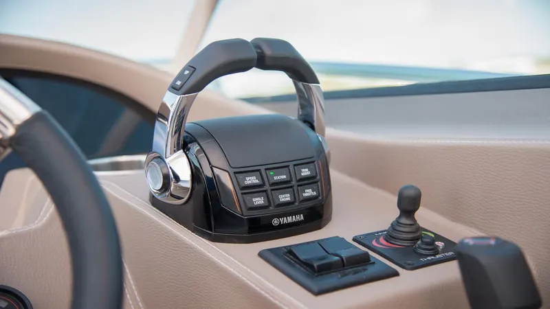 Slide: The Image of Control panel of 2026 Regal 33 XO boat featuring Yamaha throttle and joystick. - 26