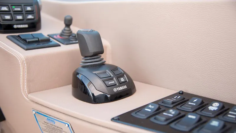 Slide: The Image of Control panel of 2026 Regal 33 XO boat featuring Yamaha joystick and buttons. - 27
