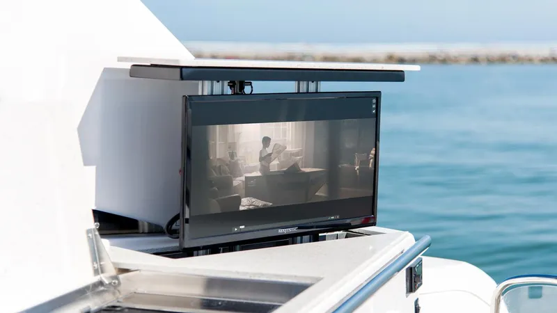 Slide: The Image of Outdoor TV on 2026 Regal 33 XO yacht, set against a serene ocean backdrop. - 29