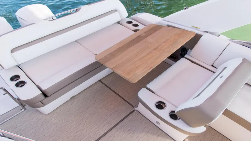 Slide: The Image of 2026 Regal 33 XO boat interior with elegant seating and wooden table. - 32