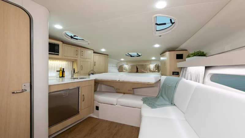 Slide: The Image of Interior of 2026 Regal 33 XO yacht with modern kitchen and cozy seating area. - 36