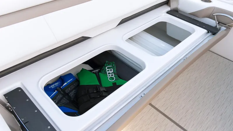 Slide: The Image of Storage compartment on 2026 Regal 33 XO boat with life jackets and gear. - 6