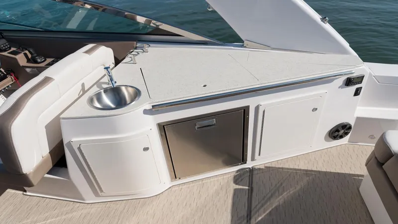 Slide: The Image of 2026 Regal 33 XO boat interior with sink and storage compartments. - 7