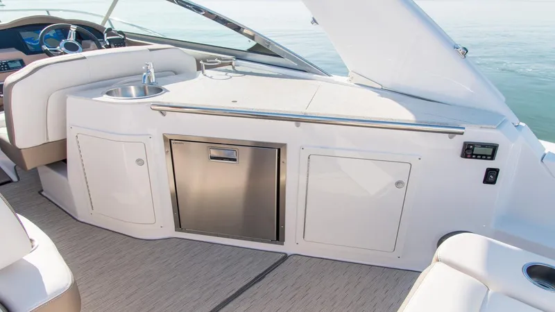 Slide: The Image of 2026 Regal 33 XO yacht interior with kitchenette and stainless steel features. - 9