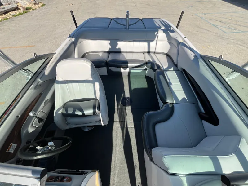 Slide: The Image of 2004 MasterCraft 210 Maristar boat interior with gray seating and steering wheel. - 11