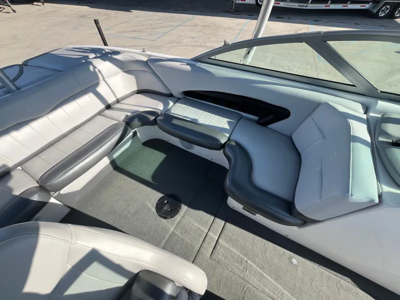 Slide: The Image of 2004 MasterCraft 210 Maristar boat interior with gray seating and carpet. - 12