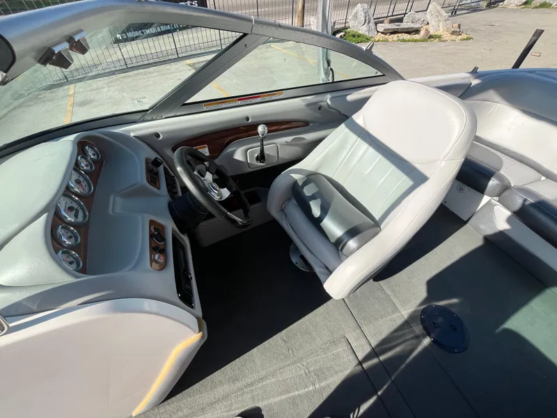 Slide: The Image of 2004 MasterCraft 210 Maristar boat interior with steering wheel and seating. - 13