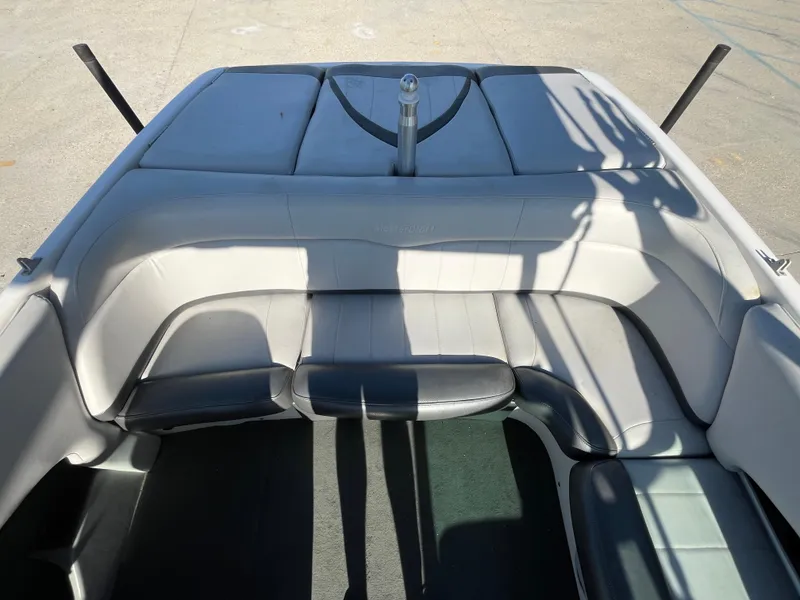 Slide: The Image of 2004 MasterCraft 210 Maristar boat interior with cushioned seating and sleek design. - 16